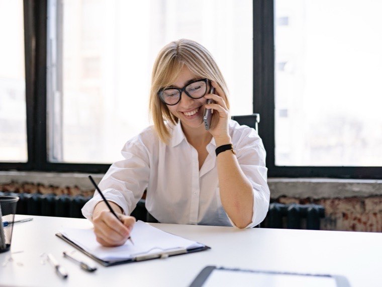 Agency coordinator taking a call at her desk